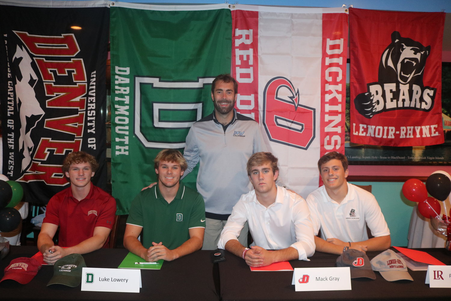 Ponte Vedra boys lacrosse head coach Chris Polanski stands behind Maddox Johnson, Luke Lowery, Mack Gray and Parker Kemp as they sign their letters of intent to play college ball Nov. 9.